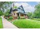 Charming two-story home with lush landscaping, well-manicured lawn, and inviting curb appeal at 3701 Eliot St, Denver, CO 80211