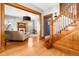 Inviting foyer with hardwood floors, wood trim, staircase, and open doorway to living room at 3701 Eliot St, Denver, CO 80211