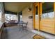 Inviting covered front porch featuring a porch swing, bistro set, and charming details at 3701 Eliot St, Denver, CO 80211