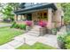 Inviting front porch with beautiful flowers, stylish steps and charming brick accents at 3701 Eliot St, Denver, CO 80211