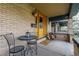Inviting front porch with a small seating area and firewood displayed, great curb appeal at 3701 Eliot St, Denver, CO 80211