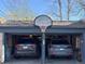 Two-car garage featuring a basketball hoop and neutral colored Jeep and Audi at 3701 Eliot St, Denver, CO 80211