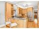 Bright kitchen features granite counters, stainless steel appliances, and light wood cabinets at 3701 Eliot St, Denver, CO 80211
