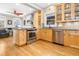 This bright kitchen features stainless appliances, granite counters, and wood floors at 3701 Eliot St, Denver, CO 80211