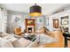 Elegant living room with fireplace and view into the dining area at 3701 Eliot St, Denver, CO 80211