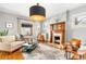 Cozy living room featuring a fireplace, large windows, and comfortable seating at 3701 Eliot St, Denver, CO 80211
