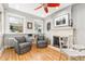 Cozy living room with fireplace, built in shelving, and lots of natural light at 3701 Eliot St, Denver, CO 80211