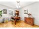 Comfortable home office with wood floors, desk, and ample natural light at 3701 Eliot St, Denver, CO 80211