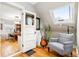 Comfortable sitting area with a chair, guitar, and skylight, adjacent to an office at 3701 Eliot St, Denver, CO 80211