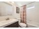 Bright bathroom with tub and patterned shower curtain at 5126 Elkhart St, Denver, CO 80239