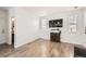 Living room with built-in shelving, TV, and access to bathroom at 5126 Elkhart St, Denver, CO 80239