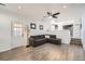 Living area with L-shaped sofa, patio door, and wood-look floors at 5126 Elkhart St, Denver, CO 80239