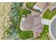 Aerial view of the home showcasing the manicured lawn, concrete patio, and adjacent gravel border along the property at 3620 Sandoval St, Brighton, CO 80601