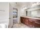 Spacious bathroom featuring a double vanity with granite countertop and tile flooring at 3620 Sandoval St, Brighton, CO 80601