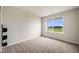 Cozy bedroom with neutral carpet and a large window offering great natural light at 3620 Sandoval St, Brighton, CO 80601
