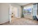 Bright bedroom with large window, carpet, and a view of the exterior at 3620 Sandoval St, Brighton, CO 80601