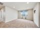 Comfortable bedroom with plush carpeting, large window with curtains, and ample space at 3620 Sandoval St, Brighton, CO 80601