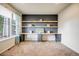 Bright bedroom with large window, built-in shelving, and cozy carpet for comfort at 3620 Sandoval St, Brighton, CO 80601