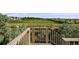 Wooden deck overlooking a green space provides a tranquil spot to relax and enjoy the scenery at 3620 Sandoval St, Brighton, CO 80601