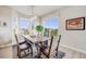 Bright dining room with large windows and a rustic wood table at 3620 Sandoval St, Brighton, CO 80601