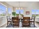 Bright dining room with large windows and a modern chandelier at 3620 Sandoval St, Brighton, CO 80601