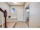 Bright entryway with wood floors, staircase, and a charming bench for added convenience at 3620 Sandoval St, Brighton, CO 80601