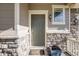 Inviting front entrance features a classic door, decorative stone accents, and stylish lighting at 3620 Sandoval St, Brighton, CO 80601