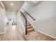 Bright hallway with wood floors, leading to a cozy living area with stairs to the upper level at 3620 Sandoval St, Brighton, CO 80601