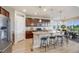 Spacious kitchen with stainless steel appliances, center island, and hardwood floors at 3620 Sandoval St, Brighton, CO 80601