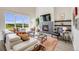 Bright living room with large windows, fireplace, and comfortable seating at 3620 Sandoval St, Brighton, CO 80601
