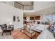 Open-concept living room with a view of the kitchen and dining area from the second floor at 3620 Sandoval St, Brighton, CO 80601