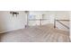 Upstairs loft area with neutral carpeting and a view to the first floor at 3620 Sandoval St, Brighton, CO 80601