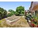 Backyard with raised flowerbeds, mature trees and shrubs, and upper-level deck at 517 Rider Ridge Dr, Longmont, CO 80504