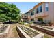 Landscaped backyard with raised flower beds, stairs to the deck, and the house at 517 Rider Ridge Dr, Longmont, CO 80504