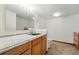 Basement bathroom featuring wood cabinets, granite counters, toilet and sink at 517 Rider Ridge Dr, Longmont, CO 80504