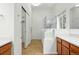 Well-lit bathroom featuring a glass enclosed shower, cabinets, and modern fixtures at 517 Rider Ridge Dr, Longmont, CO 80504