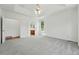 Large bright bedroom features tray ceiling, natural light, access to bathroom and arched doorway at 517 Rider Ridge Dr, Longmont, CO 80504