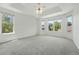Spacious bedroom with tray ceiling, neutral carpet, large windows and natural light at 517 Rider Ridge Dr, Longmont, CO 80504