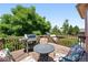 View of the deck with grill, table and chairs, and trees in the background at 517 Rider Ridge Dr, Longmont, CO 80504