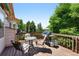 View of the deck with table, chairs, grill and propane tanks at 517 Rider Ridge Dr, Longmont, CO 80504