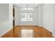 Dining room with hardwood floors, modern chandelier, and large window at 517 Rider Ridge Dr, Longmont, CO 80504