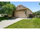 Attractive exterior view of a stone-accented home with an attached two-car garage at 517 Rider Ridge Dr, Longmont, CO 80504