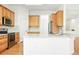 Bright kitchen featuring granite countertops, stainless appliances, and wood cabinets at 517 Rider Ridge Dr, Longmont, CO 80504