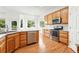 Modern kitchen with stainless appliances, ample storage, wood cabinets, and an eat-in nook at 517 Rider Ridge Dr, Longmont, CO 80504
