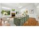 Bright living room boasts a stone fireplace, large windows, and hardwood floors at 517 Rider Ridge Dr, Longmont, CO 80504