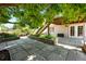 Backyard patio featuring stone pavers and landscaped flower beds, steps to deck, house, and lawn at 517 Rider Ridge Dr, Longmont, CO 80504