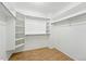 Walk-in closet with wood-look flooring and multiple shelving units at 517 Rider Ridge Dr, Longmont, CO 80504