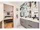 Spa-like bathroom with double vanity and view to bedroom at 1777 Larimer St # 1908, Denver, CO 80202