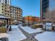 Rooftop deck with grills, seating areas, and snow-covered walkways at 1777 Larimer St # 1908, Denver, CO 80202