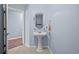 The powder room features a pedestal sink and stylish accents at 975 N Lincoln St # 3E, Denver, CO 80203
